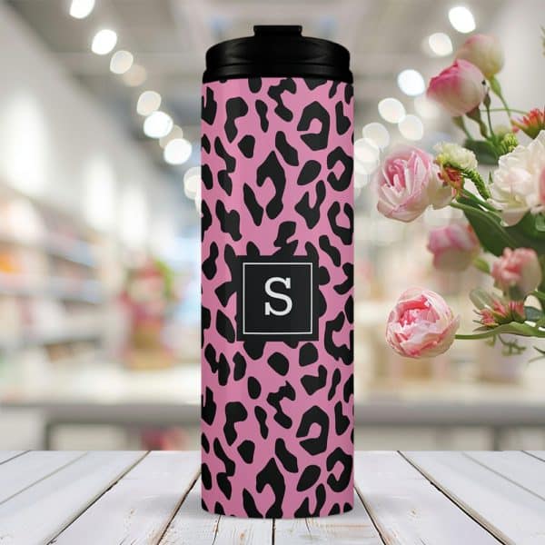 Pink Travel Tumbler With A Black Leopard Print And A Black Square Featuring The Letter S In The Center.