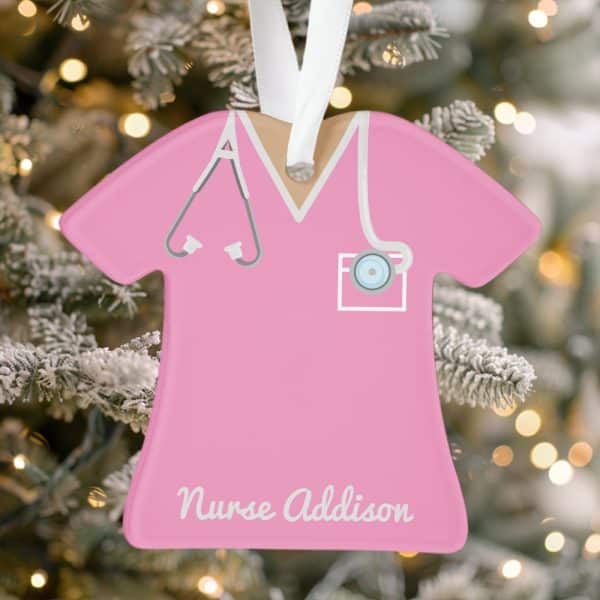 Pink Nurse Scrubs Ornament With Stethoscope And Nurse Addison Inscribed At The Bottom.