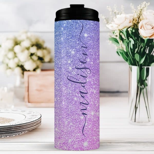 A Purple And Pink Glitter Tumbler With The Name Madison On It.
