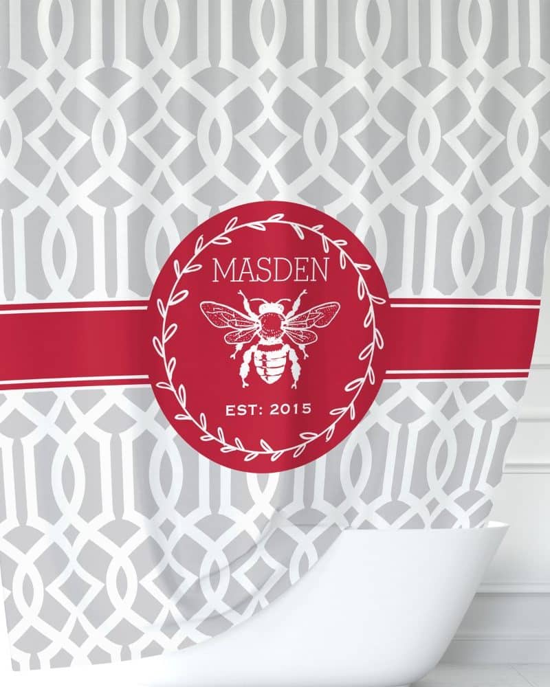 Grey and red shower curtain with a red circle featuring a bee, the name Madsen, and the year 2015.
