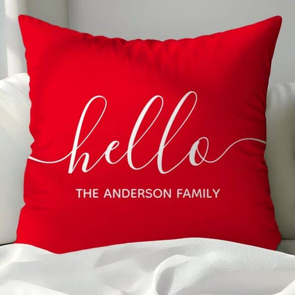 Red Pillow With White Cursive Hello And The Anderson Family.