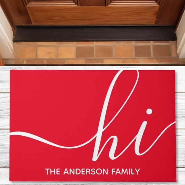 Red Welcome Mat With White Cursive &Quot;Hi&Quot; And &Quot;The Anderson Family&Quot; Below.