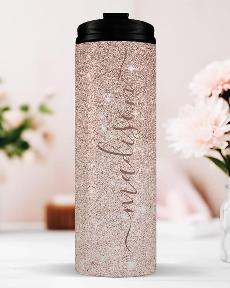 Rose gold glitter tumbler with the name Madison in a script font.
