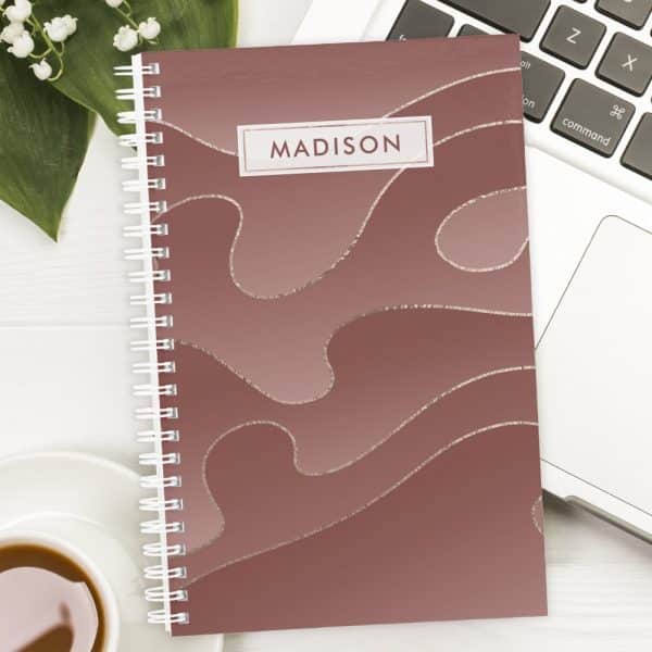 Spiral-Bound Notebook With A Dusty Rose Cover Featuring A Metallic Silver Abstract Design And The Name Madison.
