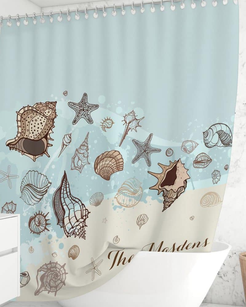 Shower curtain with a seashell and starfish design on a light blue background.