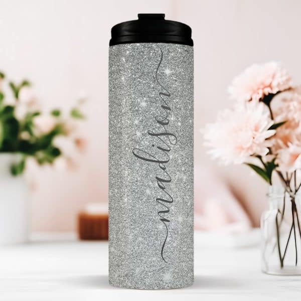 Silver Glitter Tumbler With The Name Madison In A Script Font.