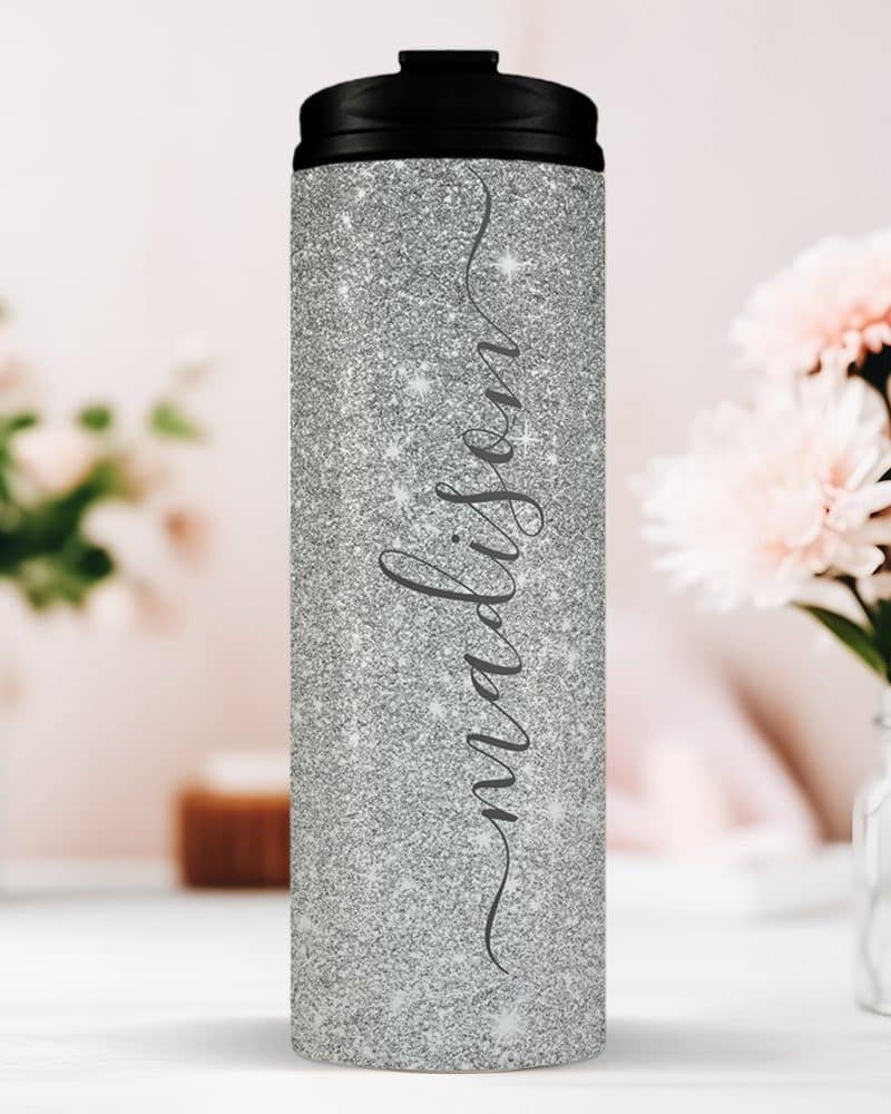 Silver glitter tumbler with the name Madison in a script font.