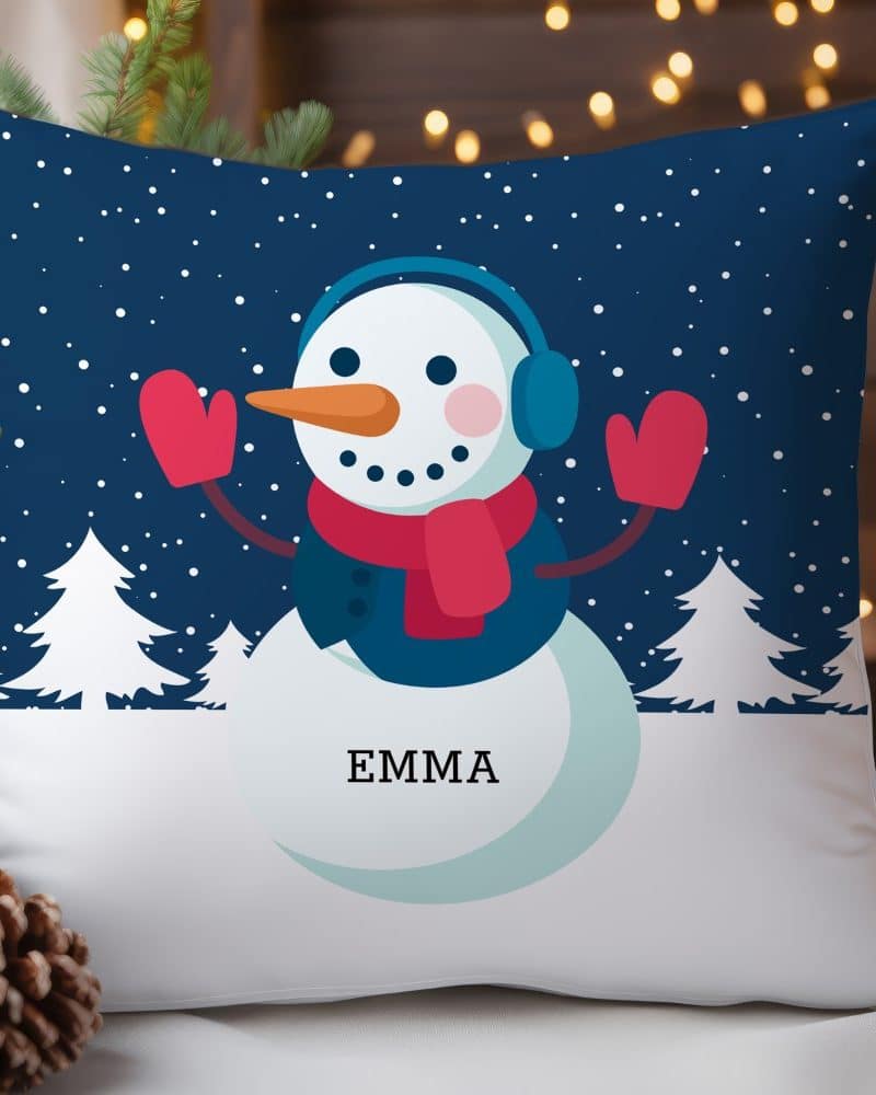 A throw pillow featuring a smiling snowman wearing earmuffs and mittens. The name Emma is printed below the snowman.
