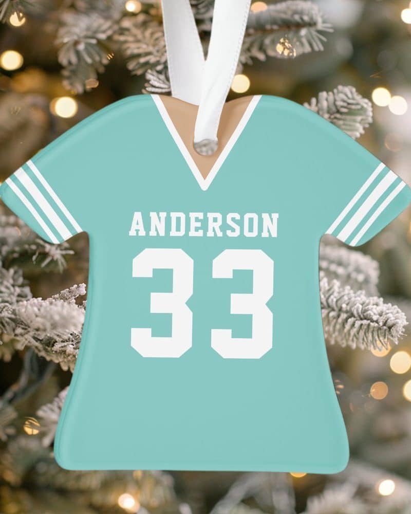 Light teal personalized jersey ornament with the name Anderson and number 33.