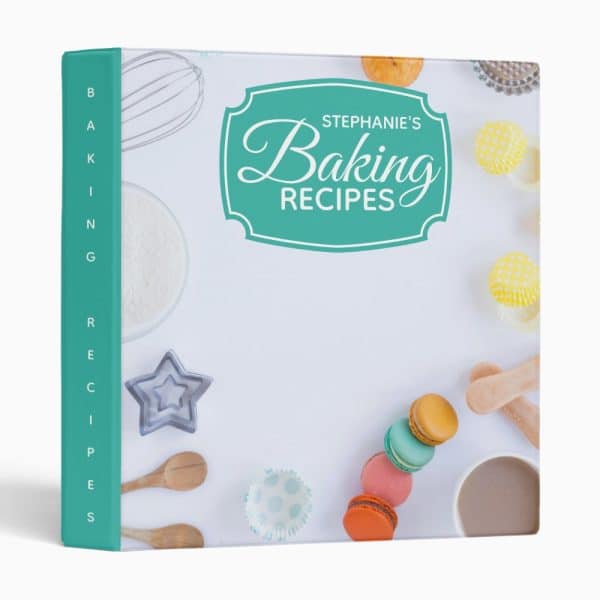A Teal Baking Recipe Binder Featuring Stephane'S Baking Recipes. Baking Utensils And Colorful Macarons Are Shown On The Cover.