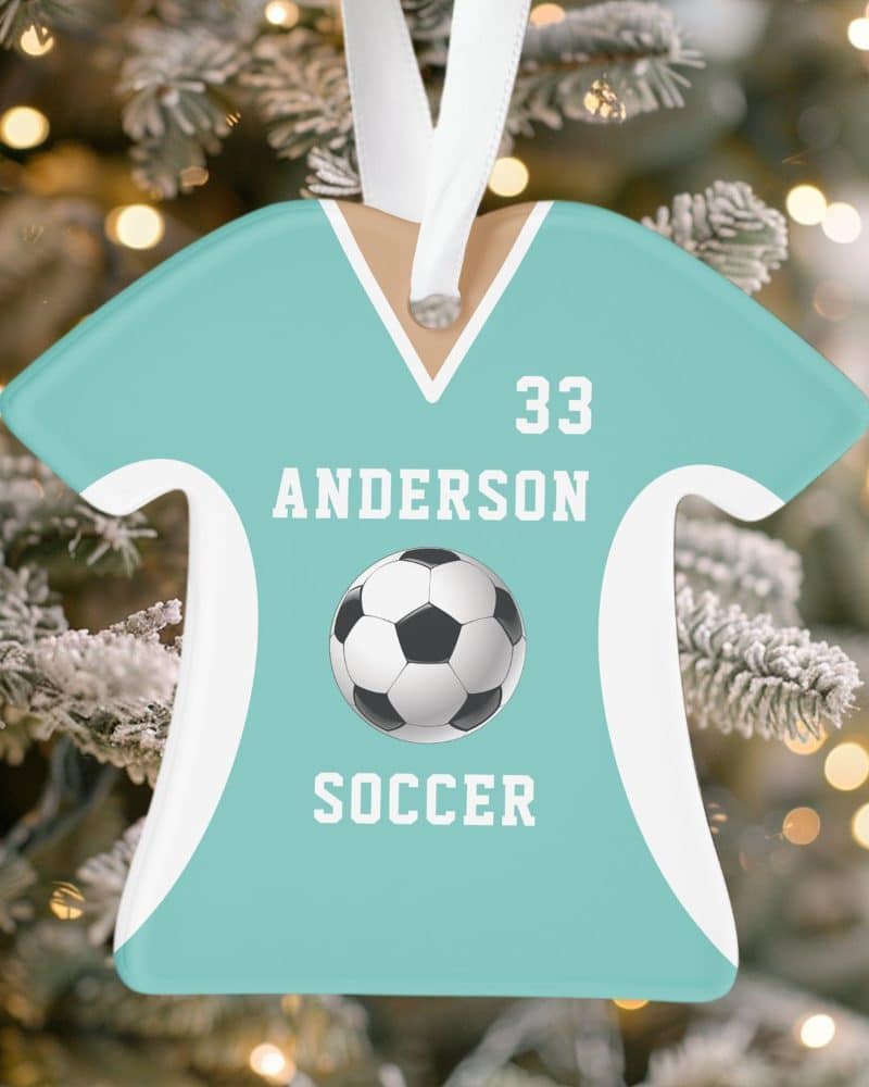 Teal soccer jersey-shaped Christmas ornament with the name Anderson, number 33, and a soccer ball.