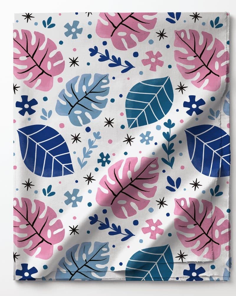 White fabric with a repeating pattern of pink and blue leaves and small flowers.