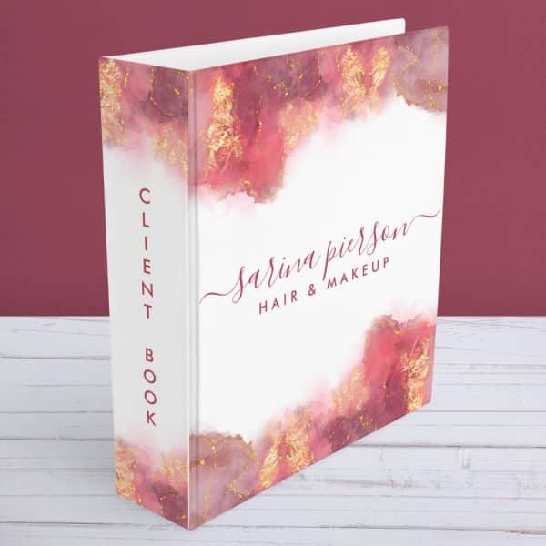 A Client Book For Sarina Pierson Hair &Amp; Makeup. The Cover Features A Watercolor Design In Shades Of Pink And Gold.