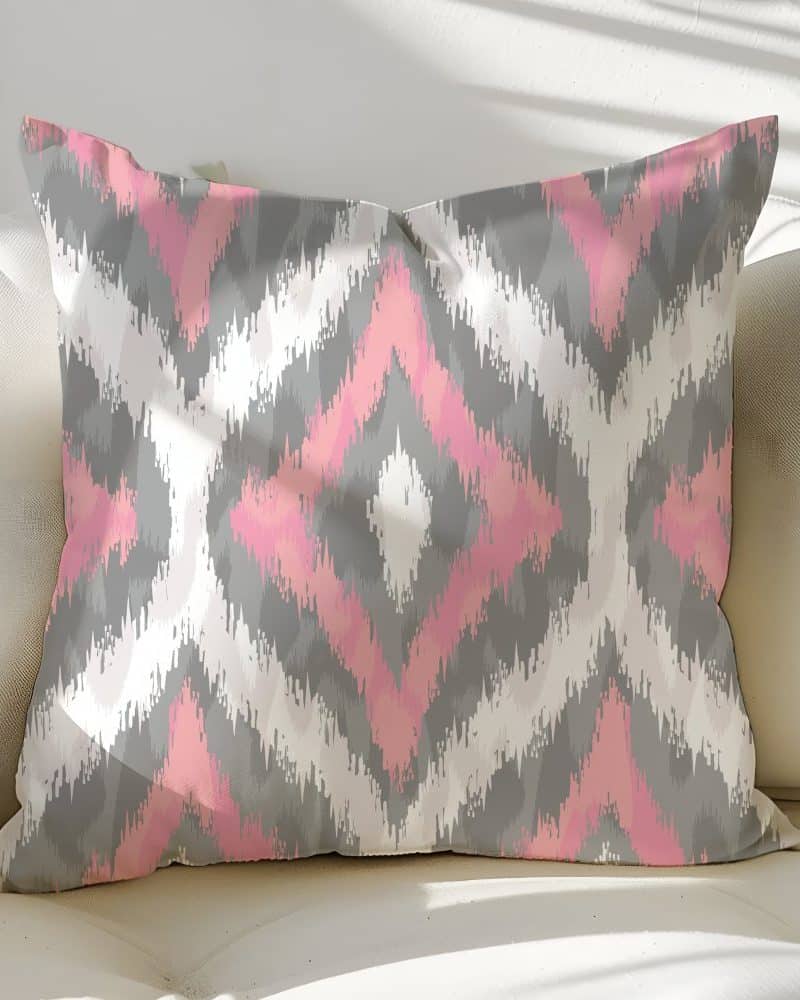 Pink and gray ikat patterned throw pillow.