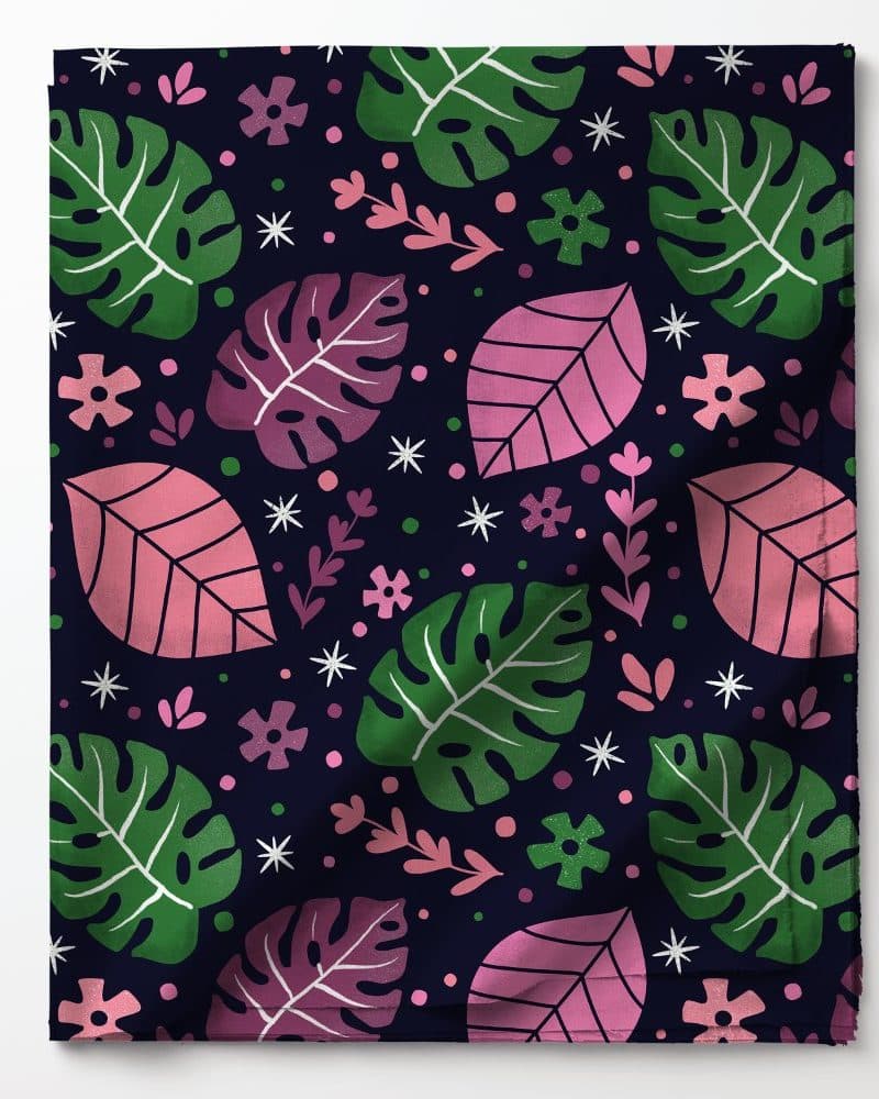 Dark blue fabric with a repeating pattern of pink and green leaves and small flowers.