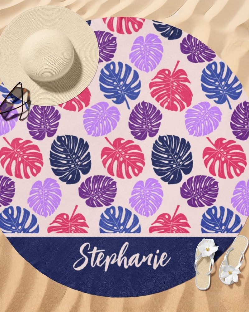 Personalized round beach towel with a tropical leaf pattern and the name Stephanie.