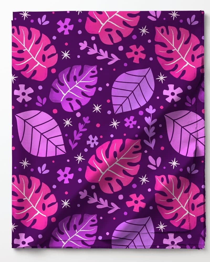 Purple fabric with a repeating pattern of pink and purple leaves and flowers.