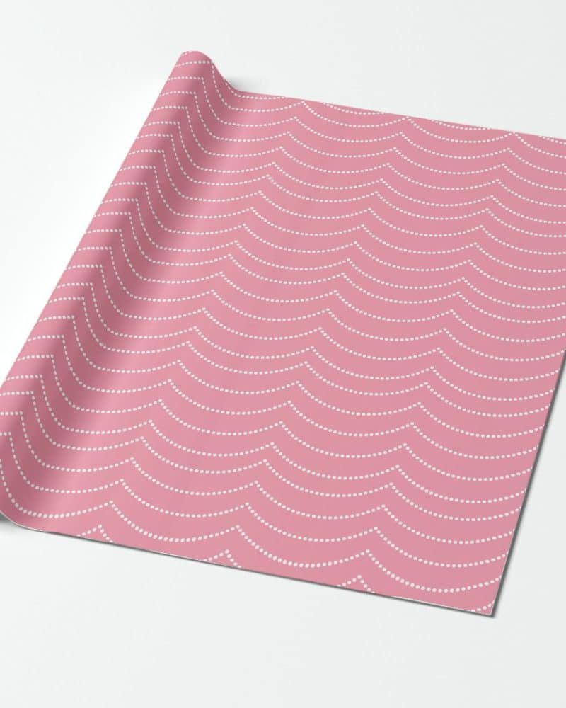 Pink wrapping paper with a white dotted wave pattern.