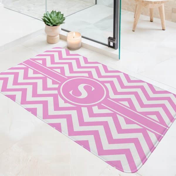 Pink And White Chevron Bath Mat With A Pink Circle Monogrammed With The Letter S.