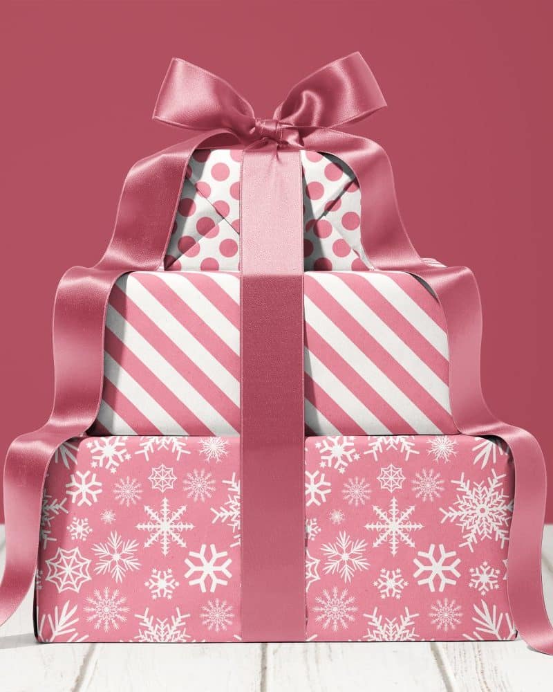 Stack of three pink gift boxes with a large pink ribbon.