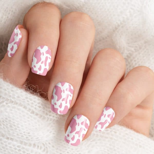 Closeup Of A Hand With Pink Cow Print Nail Art.