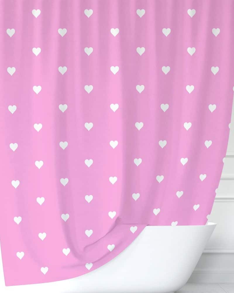 Pink shower curtain with a white heart pattern.