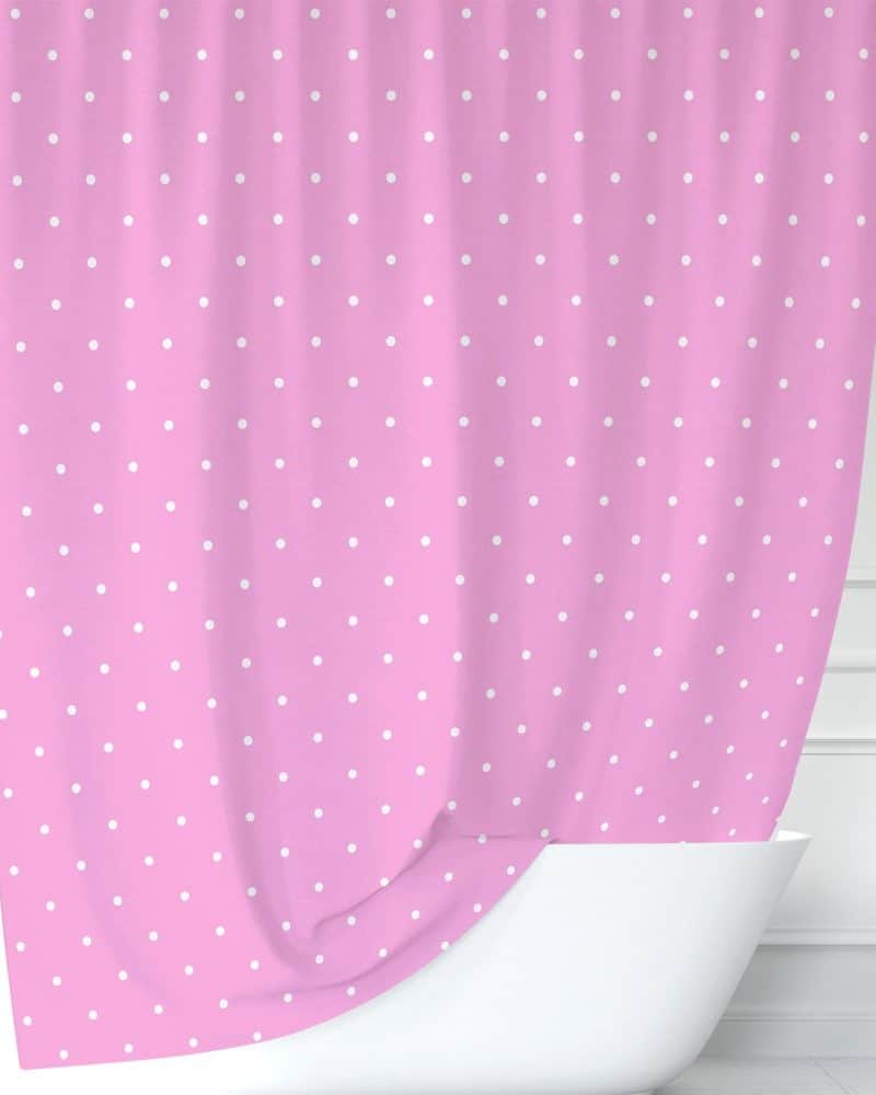 Pink shower curtain with white polka dots.