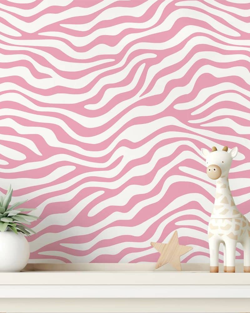 Pink zebra-striped wall with a small giraffe toy and a succulent plant on a white shelf.