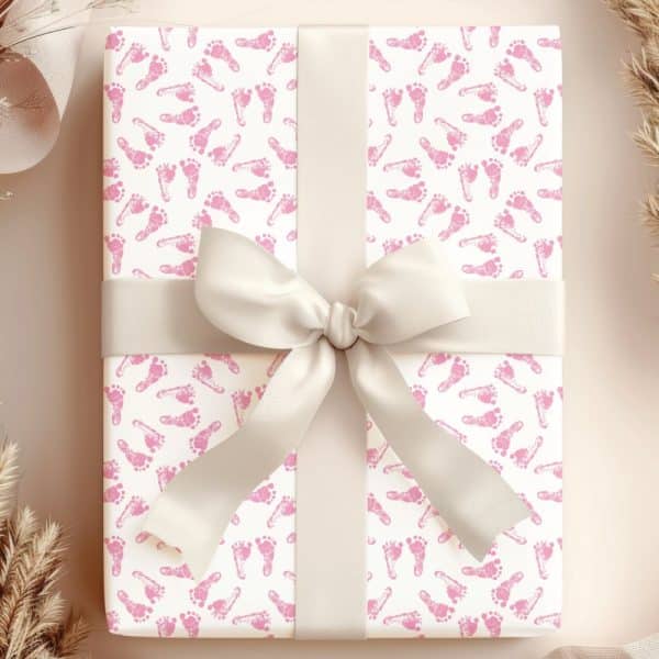 Gift Wrapped In Pink Baby Footprints Wrapping Paper With A Cream-Colored Ribbon.