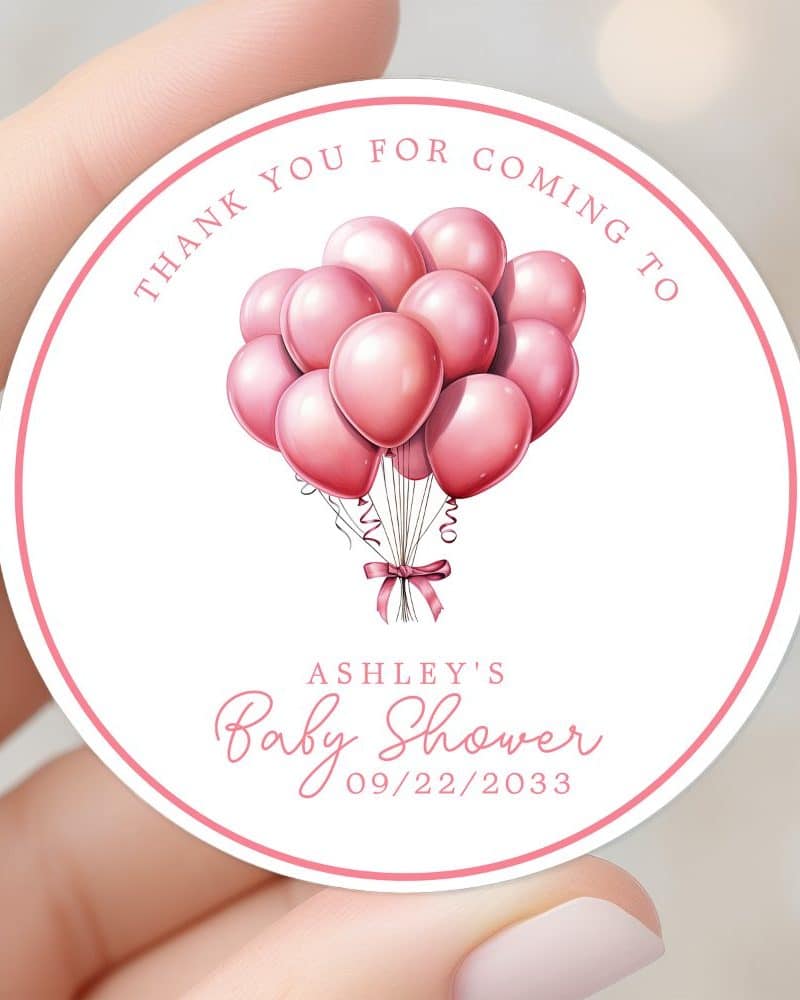 Round baby shower thank you sticker featuring pink balloons tied with a pink ribbon. The sticker includes Ashley's Baby Shower and the date 09/22/2033.