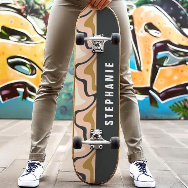 Person Holding A Personalized Skateboard With An Abstract Design And The Name Stephanie.