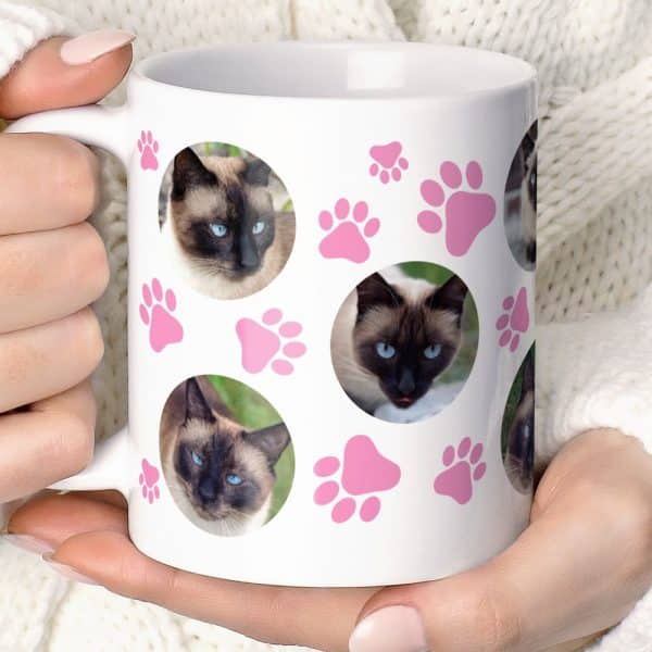 White Coffee Mug With Pink Paw Prints And Several Photos Of A Siamese Cat.