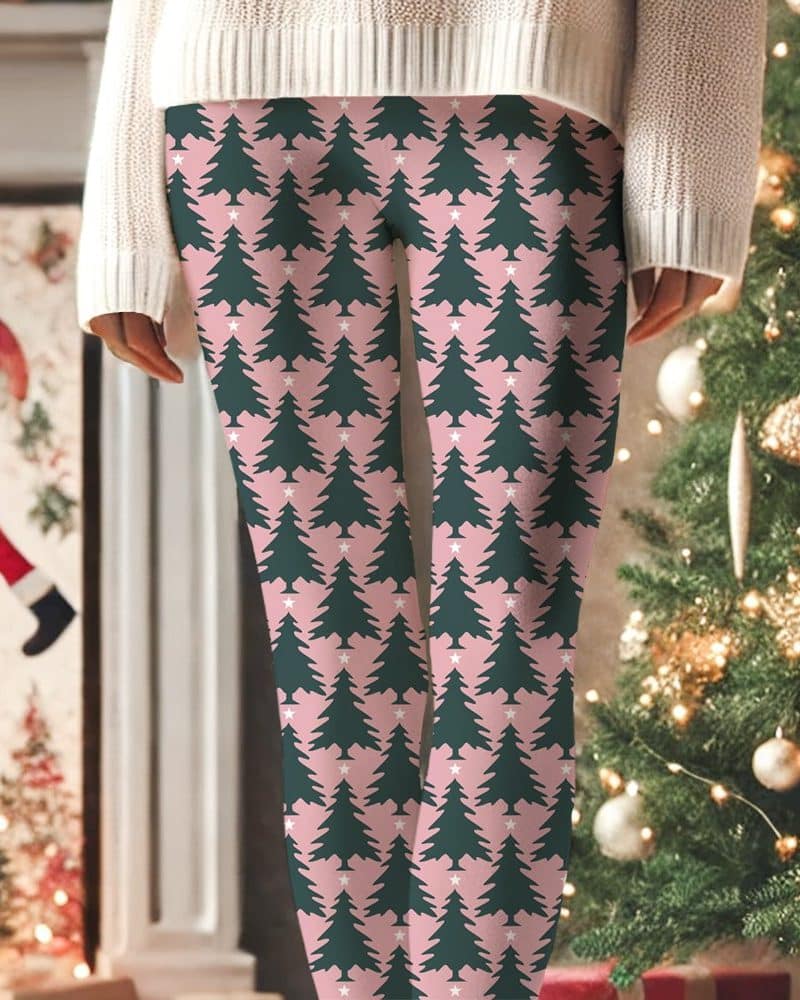 Pink leggings with a repeating pattern of dark green Christmas trees and small white stars.