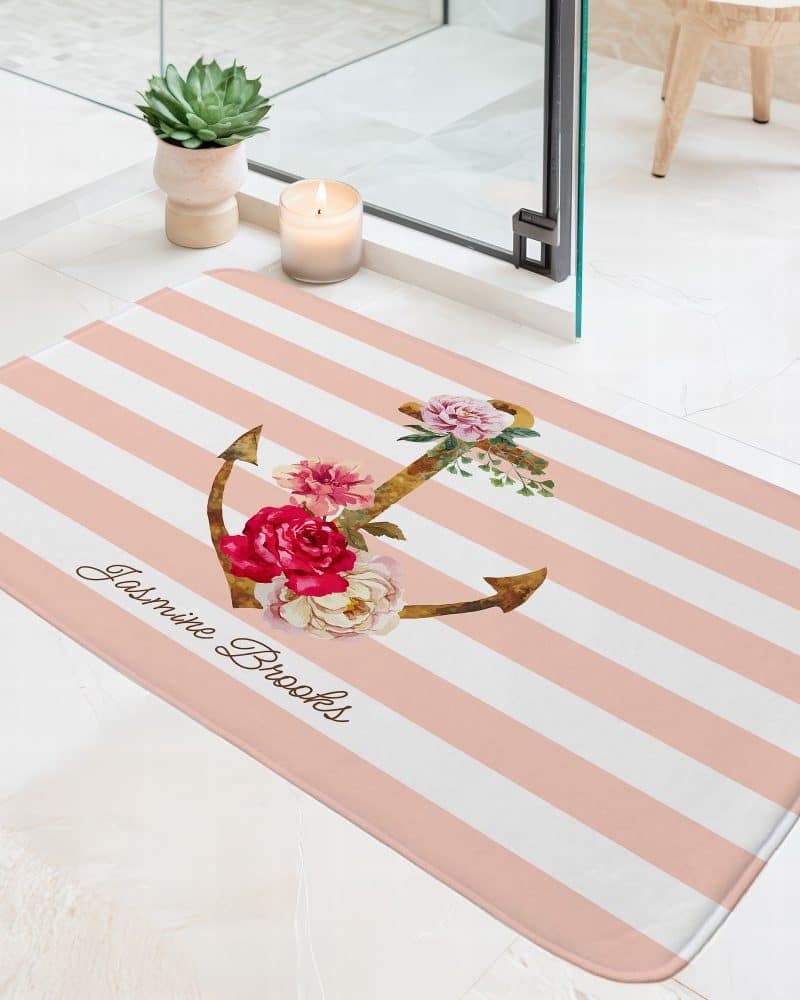 Pink and white striped bath mat with a floral anchor and personalized name.
