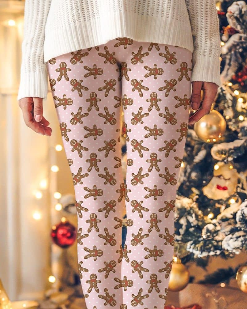 Pink leggings with a repeating pattern of gingerbread men.