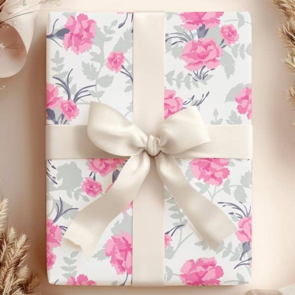 A Gift Wrapped In Pink Floral Paper With A Cream-Colored Ribbon.