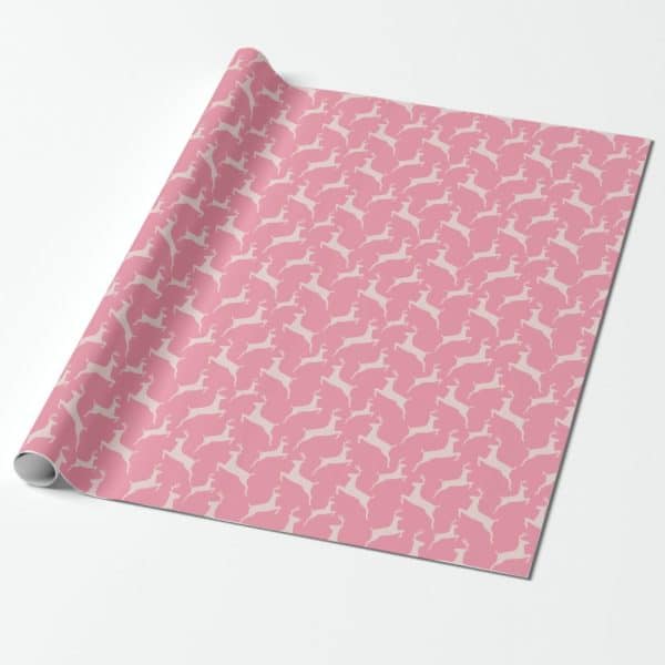 Pink Wrapping Paper With A Repeating Pattern Of Off-White Deer Silhouettes.