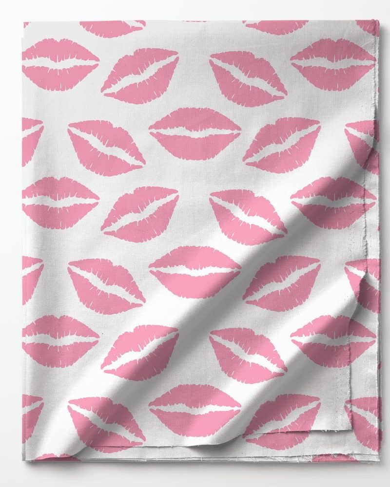 Pink lipstick print on white fabric.
