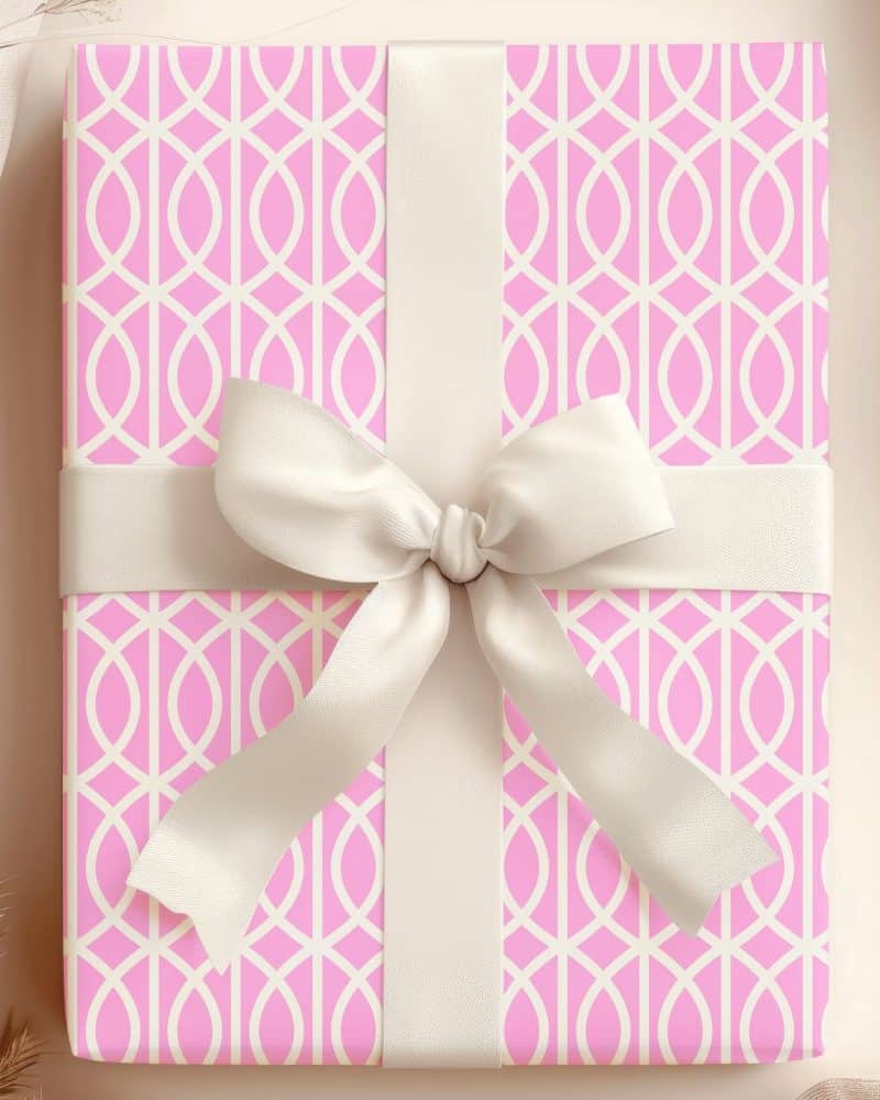 Pink gift box with a cream-colored ribbon.