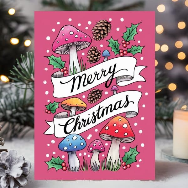Pink Christmas Card Featuring Colorful Mushrooms, Pine Cones, Holly, And The Text Merry Christmas.