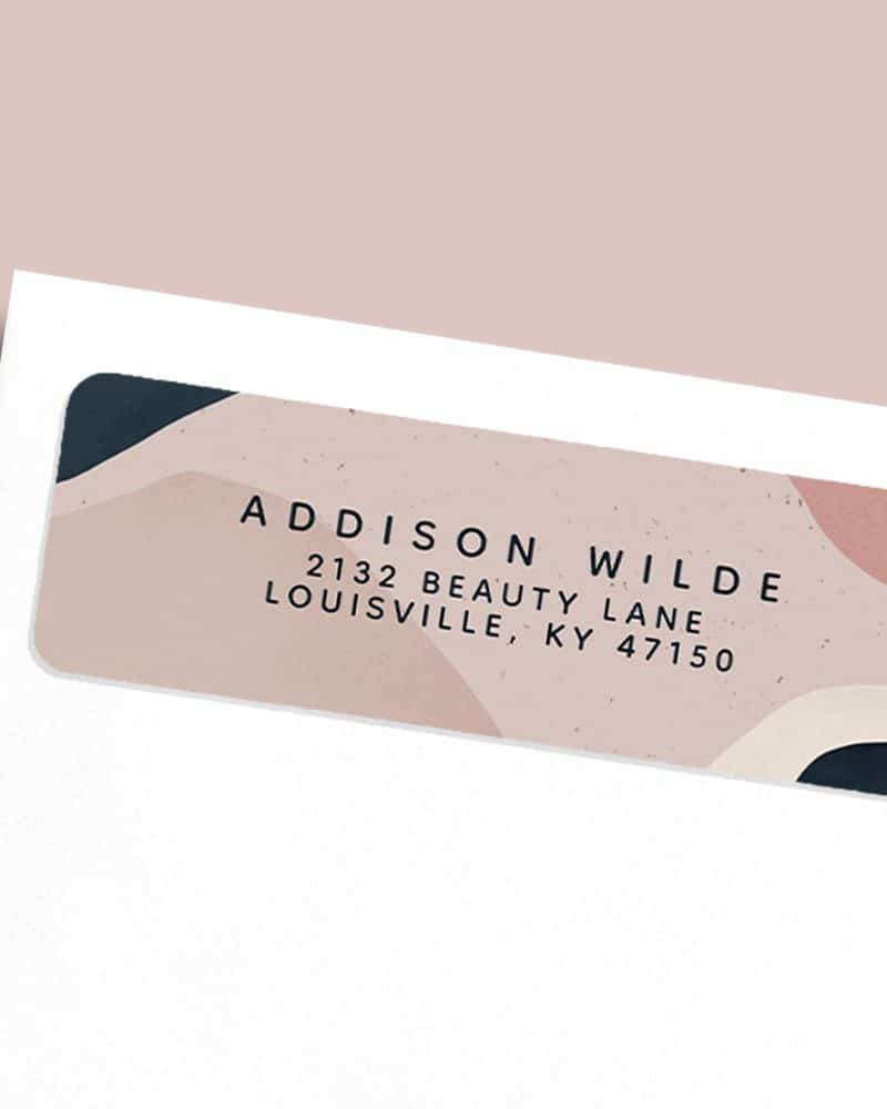 Return address label with abstract shapes in muted pink and beige, and dark text giving the name and address Addison Wilde, 2132 Beauty Lane, Louisville, KY 47150.