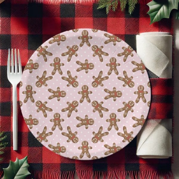 Pink Paper Plate With A Repeating Pattern Of Gingerbread Men, Set On A Red And Black Plaid Surface.