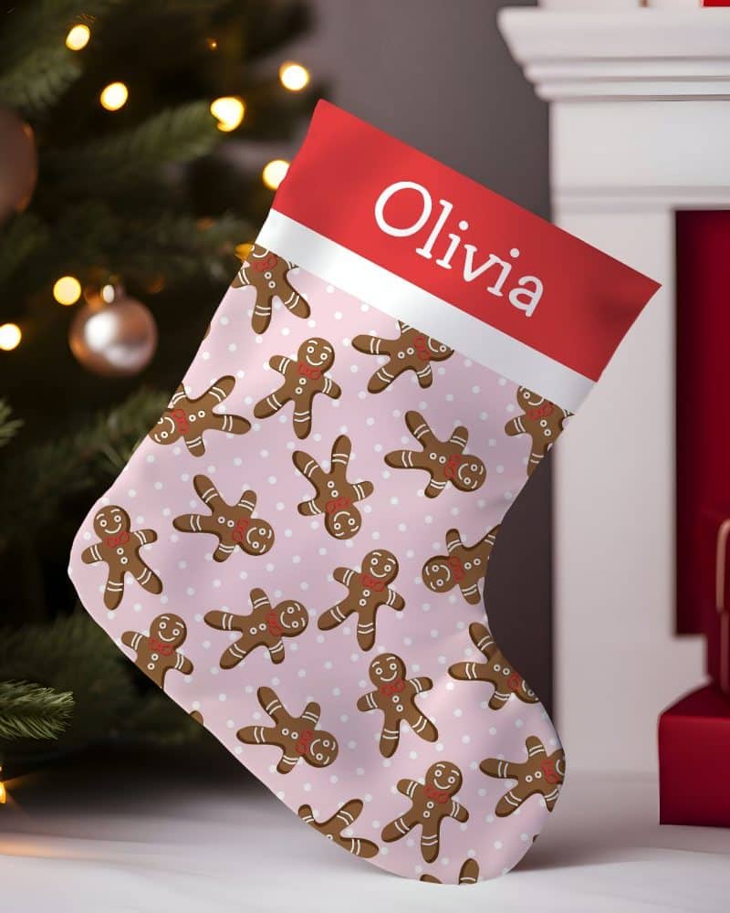 Pink Christmas stocking with gingerbread men pattern and Olivia's name.