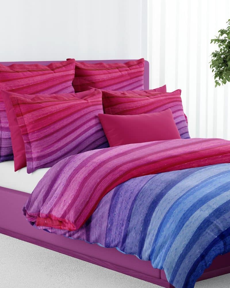 Purple bed with a colorful striped duvet cover and matching pillows.