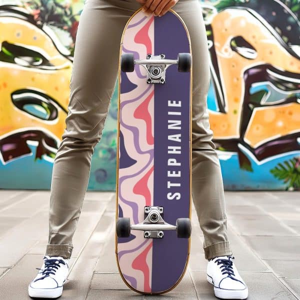 Person Holding A Purple And Pink Skateboard With The Name Stephanie On It.