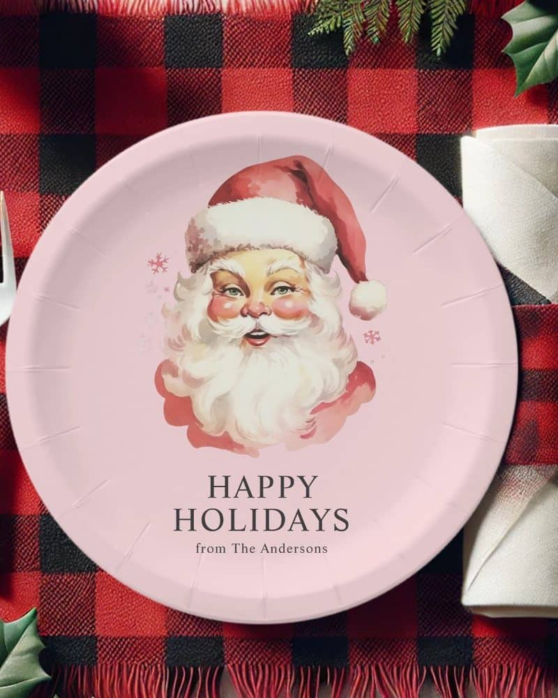 Pink paper plate featuring a vintage illustration of Santa Claus, with the text Happy Holidays from The Andersons.