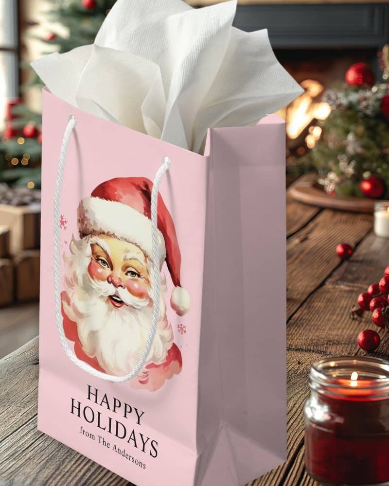 Pink gift bag with a vintage Santa Claus illustration and Happy Holidays text.