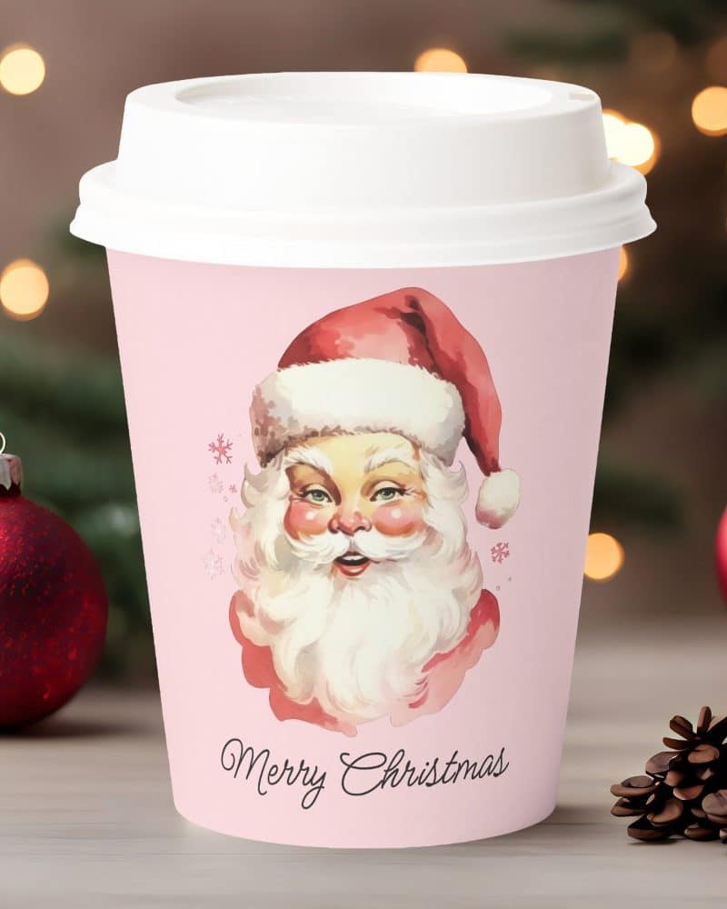 Pink Christmas coffee cup featuring a vintage Santa Claus illustration and the words Merry Christmas.