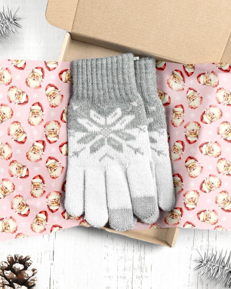 Pair of grey and white knit gloves in a gift box.
