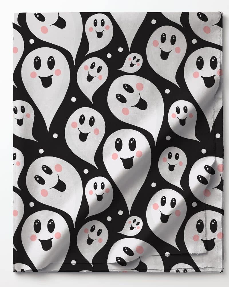 Black fabric with a repeating pattern of white smiling ghosts.